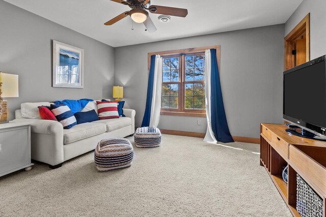 living room with light colored carpet and ceiling fan