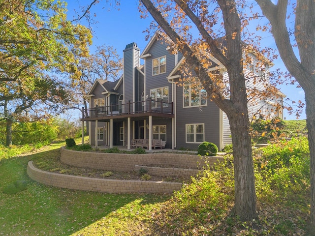 rear view of property with a patio and a yard