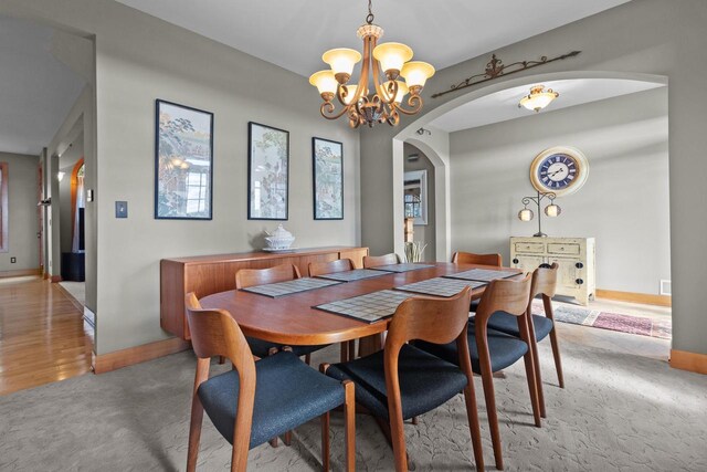 dining area with an inviting chandelier and hardwood / wood-style floors