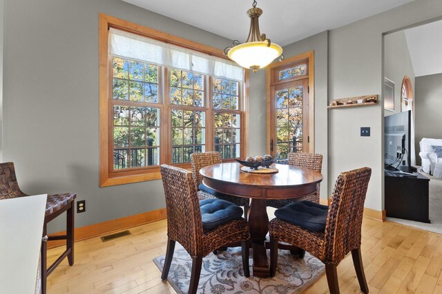 dining area featuring light hardwood / wood-style flooring and lofted ceiling