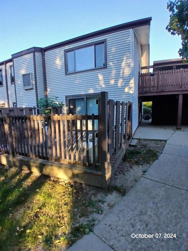 rear view of house featuring a wooden deck