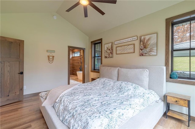 bedroom featuring ceiling fan, multiple windows, vaulted ceiling, and light hardwood / wood-style flooring