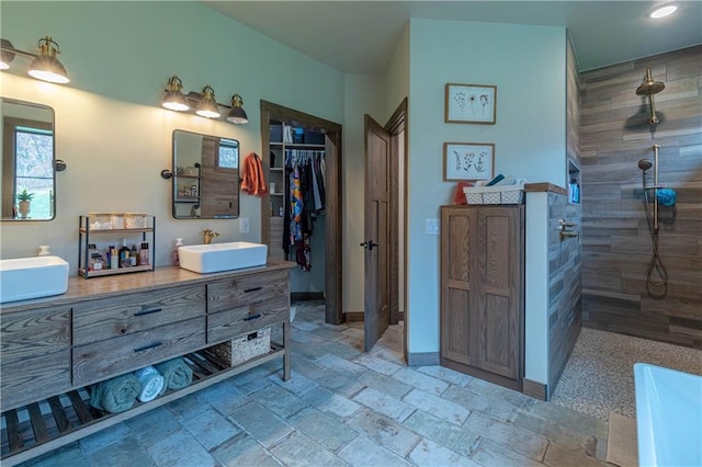 bathroom with vanity and tiled shower