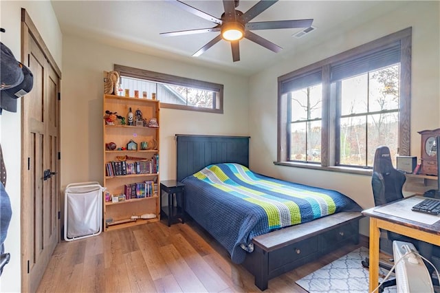 bedroom with light hardwood / wood-style floors and ceiling fan