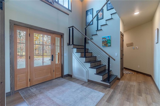 foyer entrance with light hardwood / wood-style floors