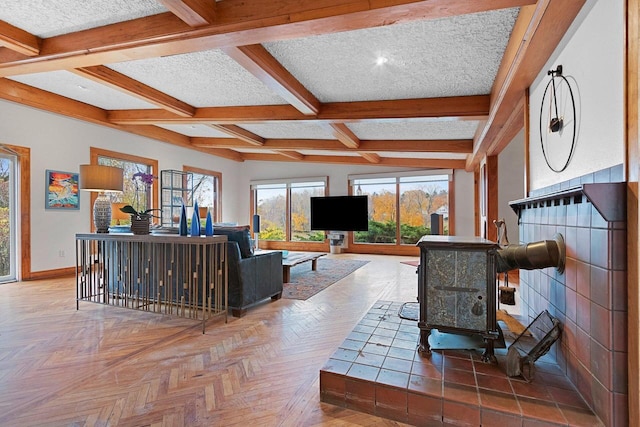 living room with parquet flooring, a textured ceiling, beamed ceiling, and coffered ceiling