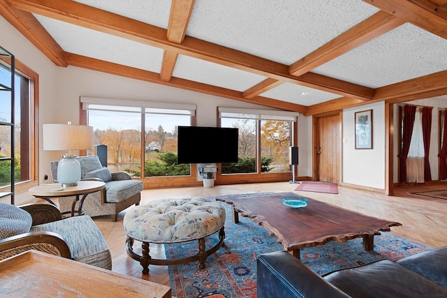 living room with lofted ceiling with beams, hardwood / wood-style flooring, a textured ceiling, and plenty of natural light