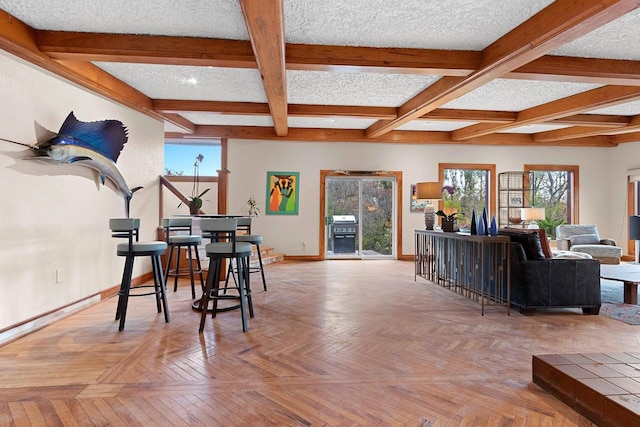 dining room with coffered ceiling, beam ceiling, light parquet flooring, and a textured ceiling