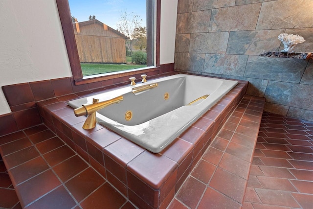 bathroom with tiled tub and tile walls