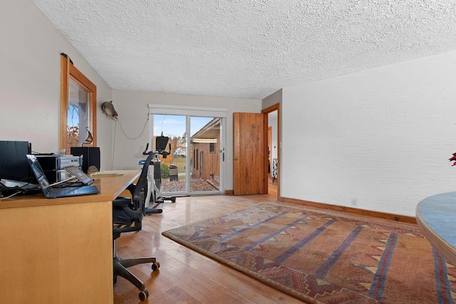 office area featuring hardwood / wood-style floors and a textured ceiling