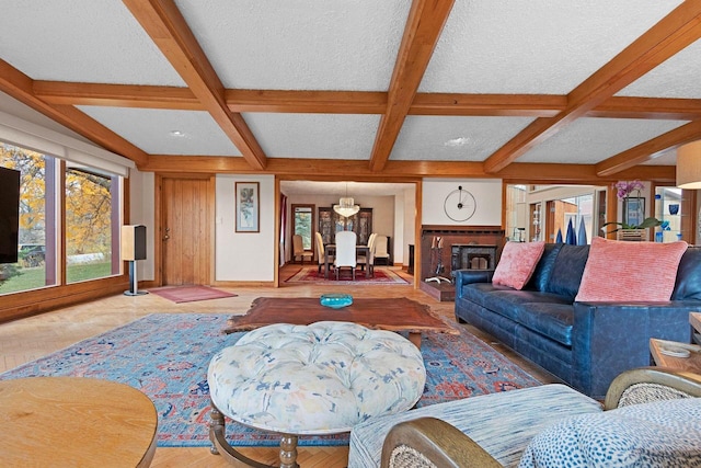 living room featuring beam ceiling, coffered ceiling, and a textured ceiling