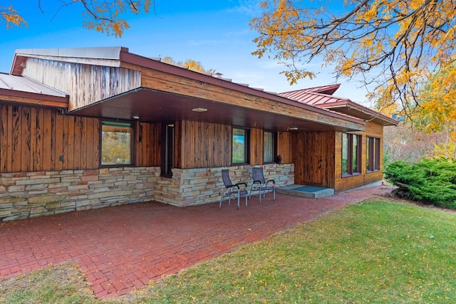 rear view of property with a patio area and a lawn