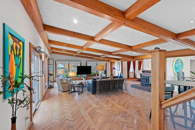 living room with a textured ceiling, light parquet flooring, a wood stove, lofted ceiling with beams, and coffered ceiling