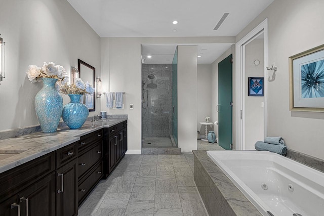 bathroom with vanity and shower with separate bathtub