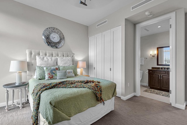 carpeted bedroom with ensuite bathroom