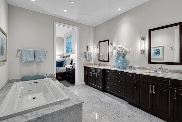 bathroom featuring vanity and a relaxing tiled tub