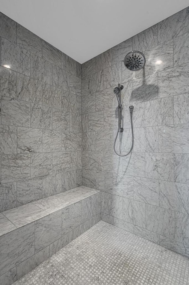 bathroom with a tile shower