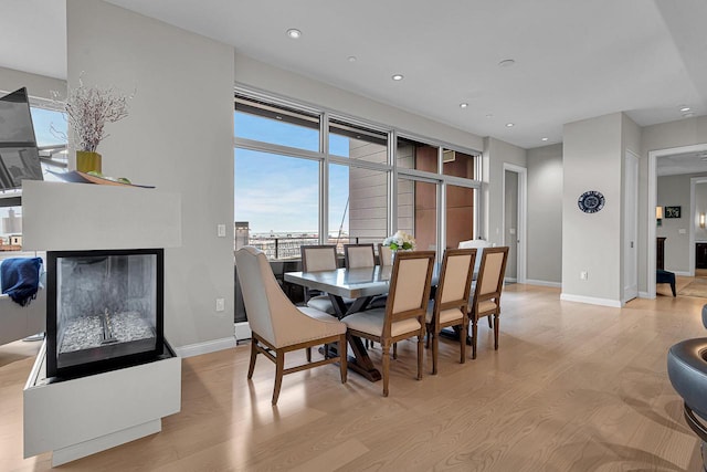 dining space with light hardwood / wood-style flooring