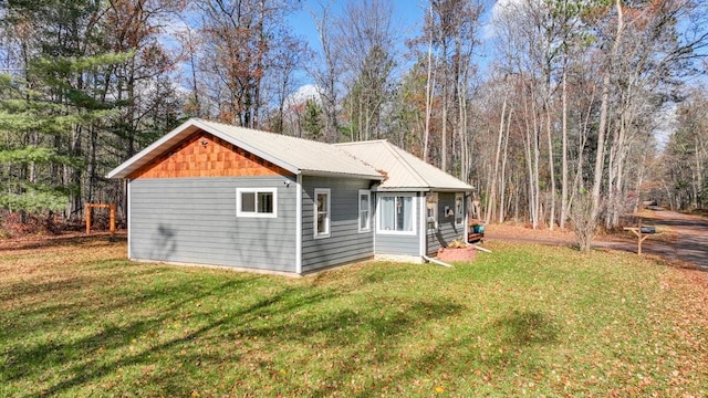 view of side of home featuring a yard