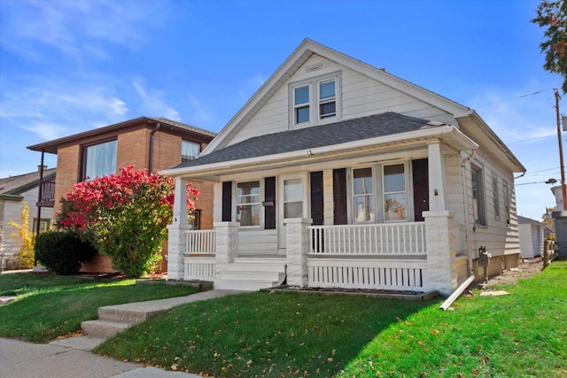 bungalow with a front lawn and a porch