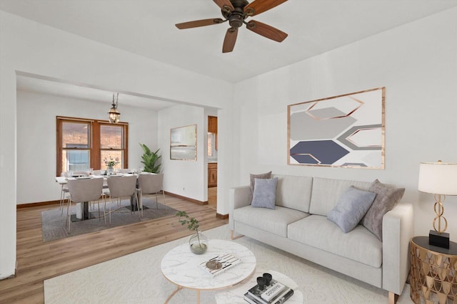 living room featuring hardwood / wood-style flooring and ceiling fan