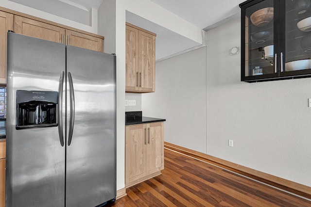 kitchen featuring light brown cabinets, dark hardwood / wood-style floors, and stainless steel fridge