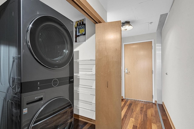 laundry area featuring stacked washer / dryer and hardwood / wood-style floors