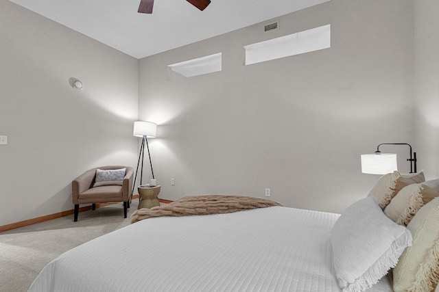 carpeted bedroom featuring ceiling fan and a skylight