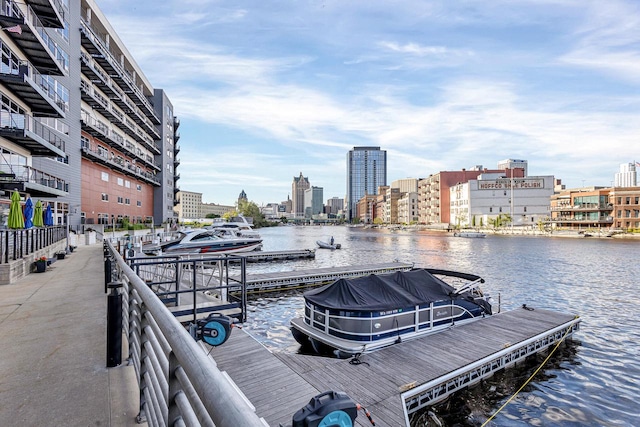 view of dock featuring a water view and a balcony