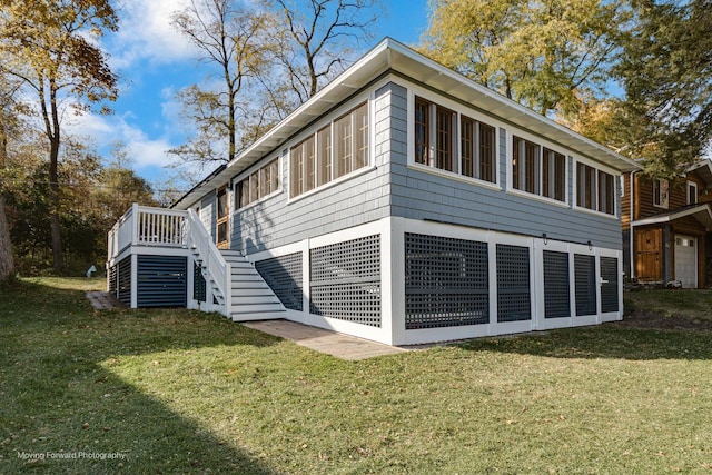 view of home's exterior featuring a deck and a lawn