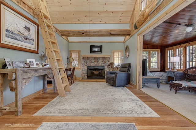 living room with vaulted ceiling, light hardwood / wood-style flooring, a fireplace, and wooden ceiling