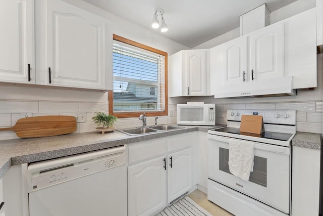 kitchen with white appliances, backsplash, white cabinetry, and sink