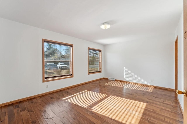 spare room with hardwood / wood-style floors