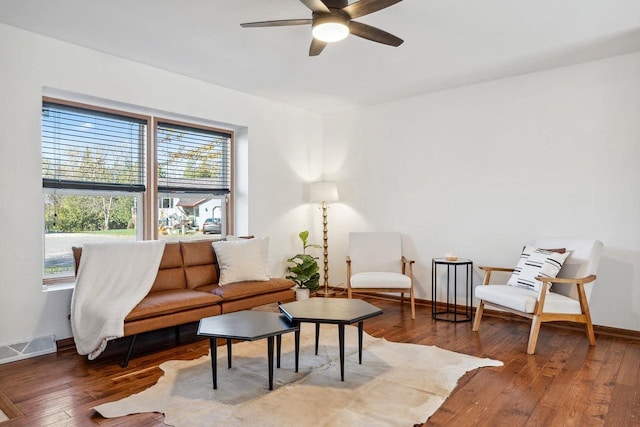 living area featuring hardwood / wood-style floors and ceiling fan