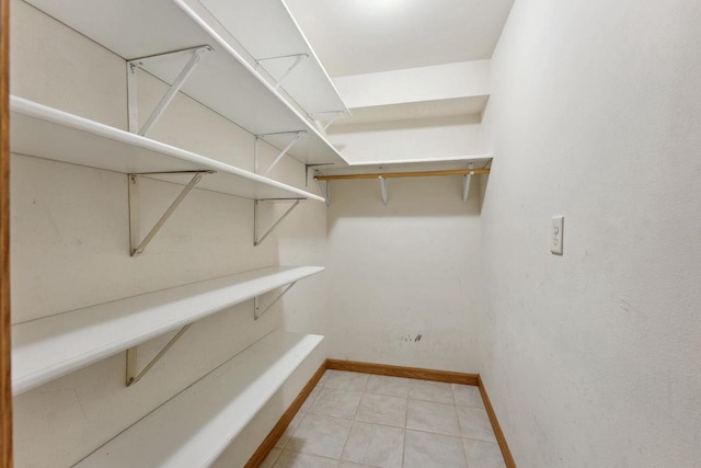 walk in closet featuring light tile patterned floors