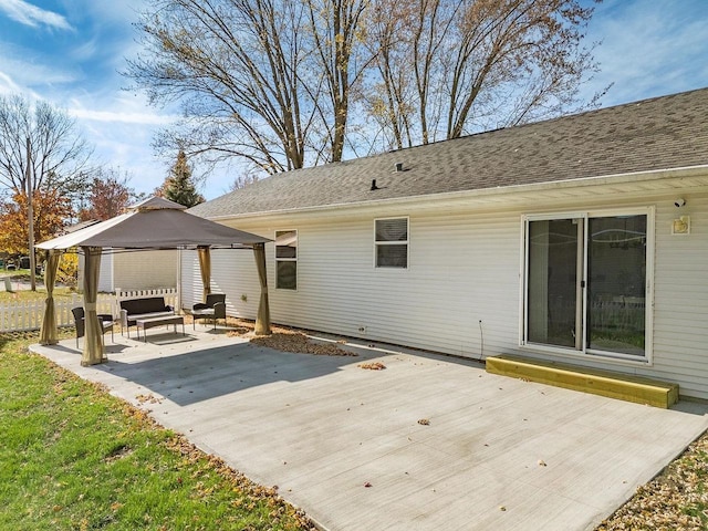 rear view of house with a gazebo and a patio area