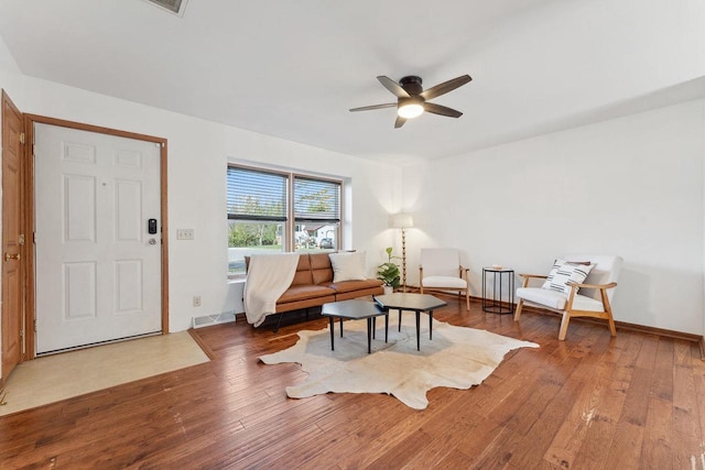 sitting room featuring wood-type flooring and ceiling fan