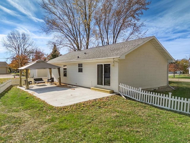 back of property with a patio area and a yard