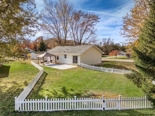 back of property featuring a yard and a patio