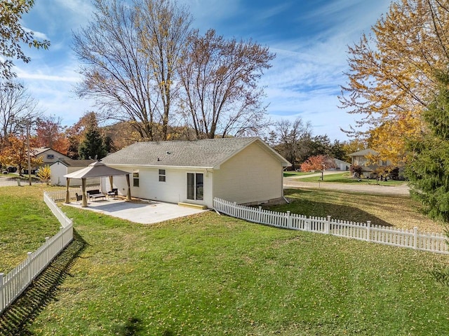 rear view of property with a patio area and a lawn