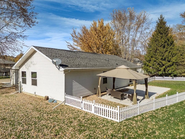 back of house with a patio area and a lawn