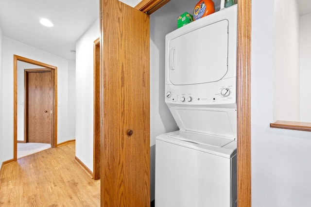 washroom featuring stacked washer / dryer and light wood-type flooring