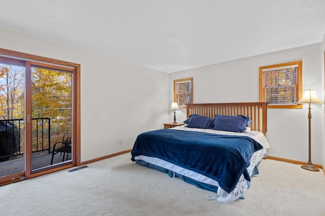 bedroom featuring access to exterior and carpet floors