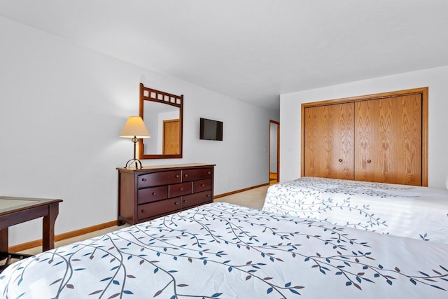 bedroom featuring a closet and light colored carpet