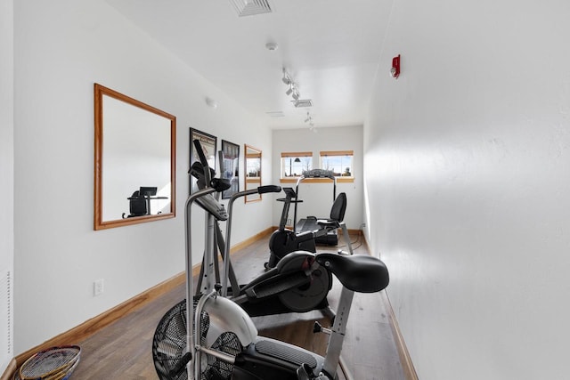 exercise room with wood-type flooring