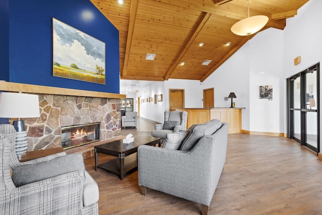 living room featuring high vaulted ceiling, hardwood / wood-style flooring, wooden ceiling, and beam ceiling