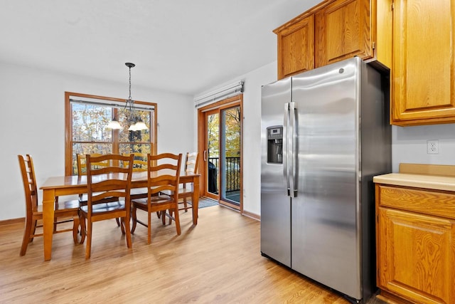 kitchen with light hardwood / wood-style flooring, pendant lighting, an inviting chandelier, and stainless steel refrigerator with ice dispenser