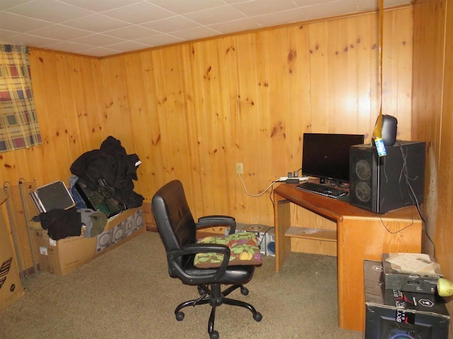 office area with wood walls and carpet flooring