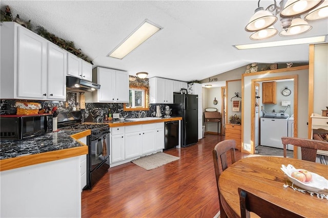 kitchen featuring lofted ceiling, white cabinetry, and black appliances