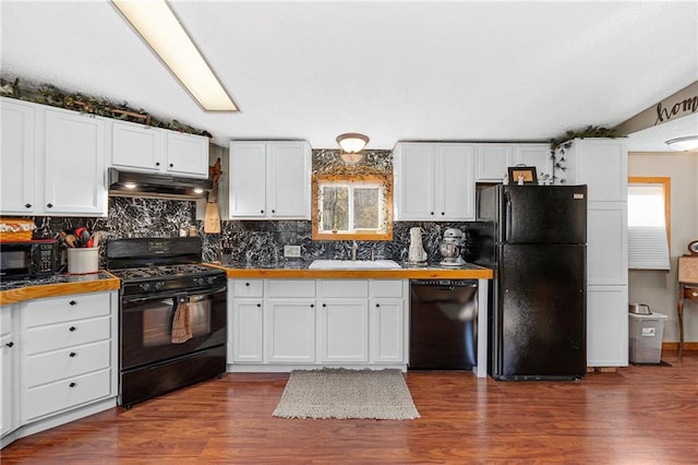 kitchen featuring sink, black appliances, white cabinets, and dark wood-type flooring